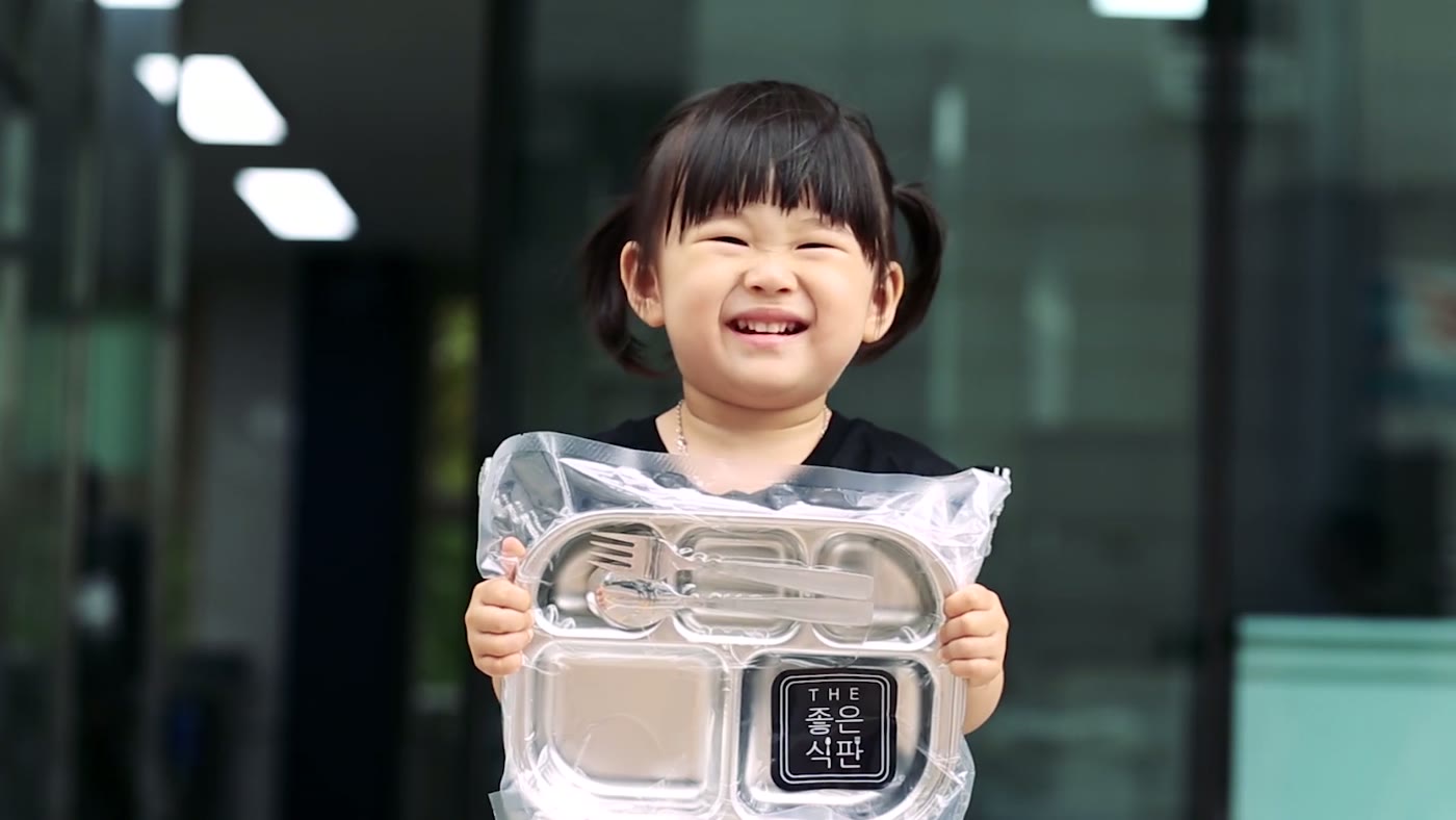 진공 포장된 THE 좋은식판 식판을 들고 웃는 아이